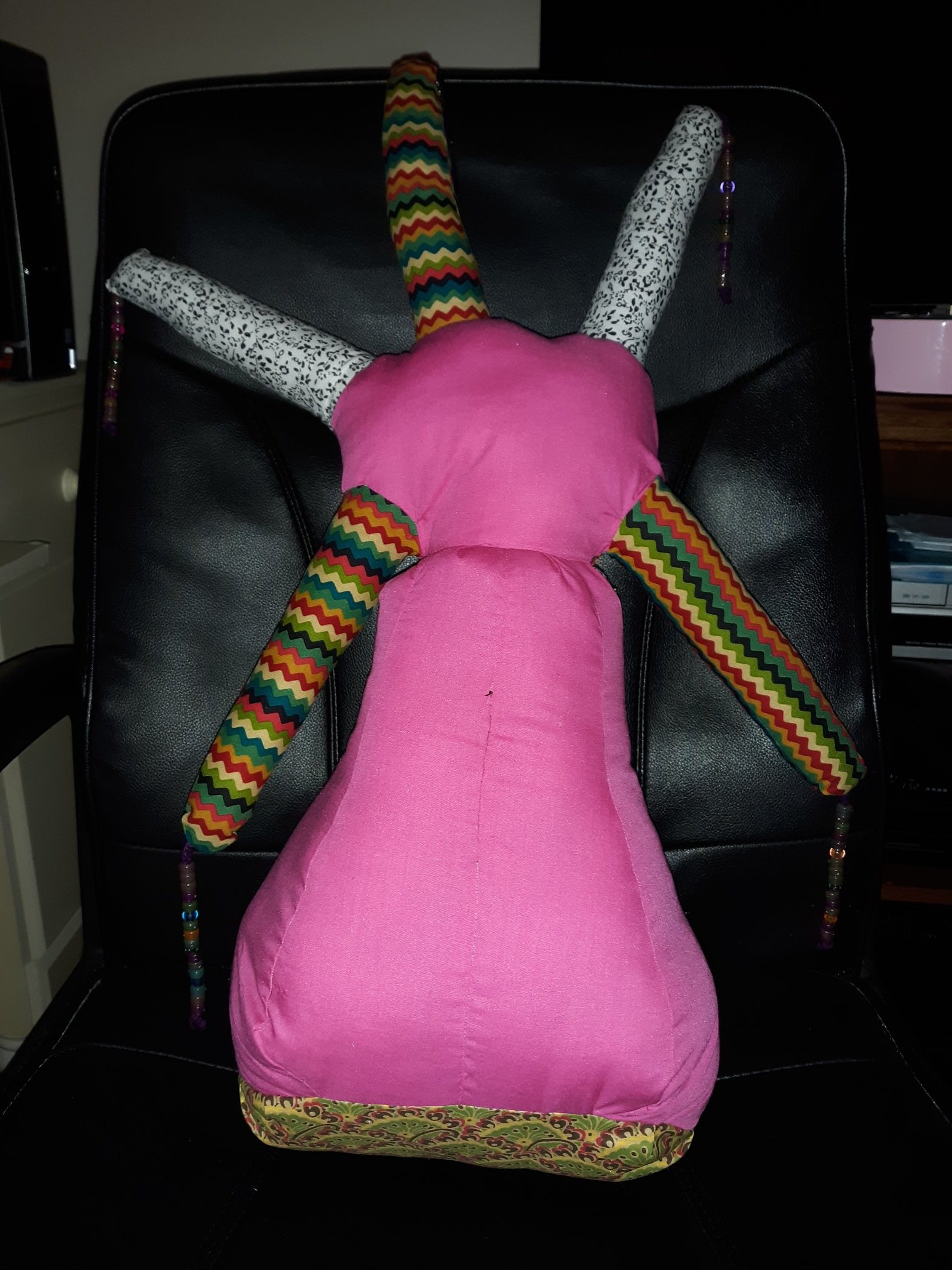 The back of the doll. It's the same as the front, but with no face. The legs are hidden.