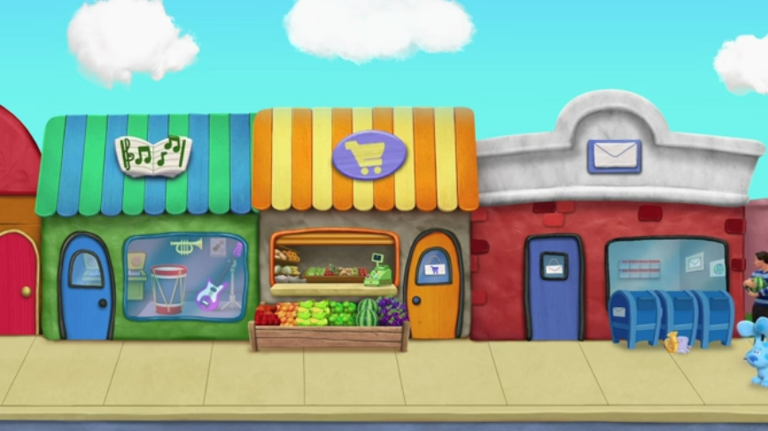 Josh and Blue are still in the neighborhood. There are three different buildings this time. The first one is of a green music store. The second one is of an orange grocery store. The third building is the red post office.