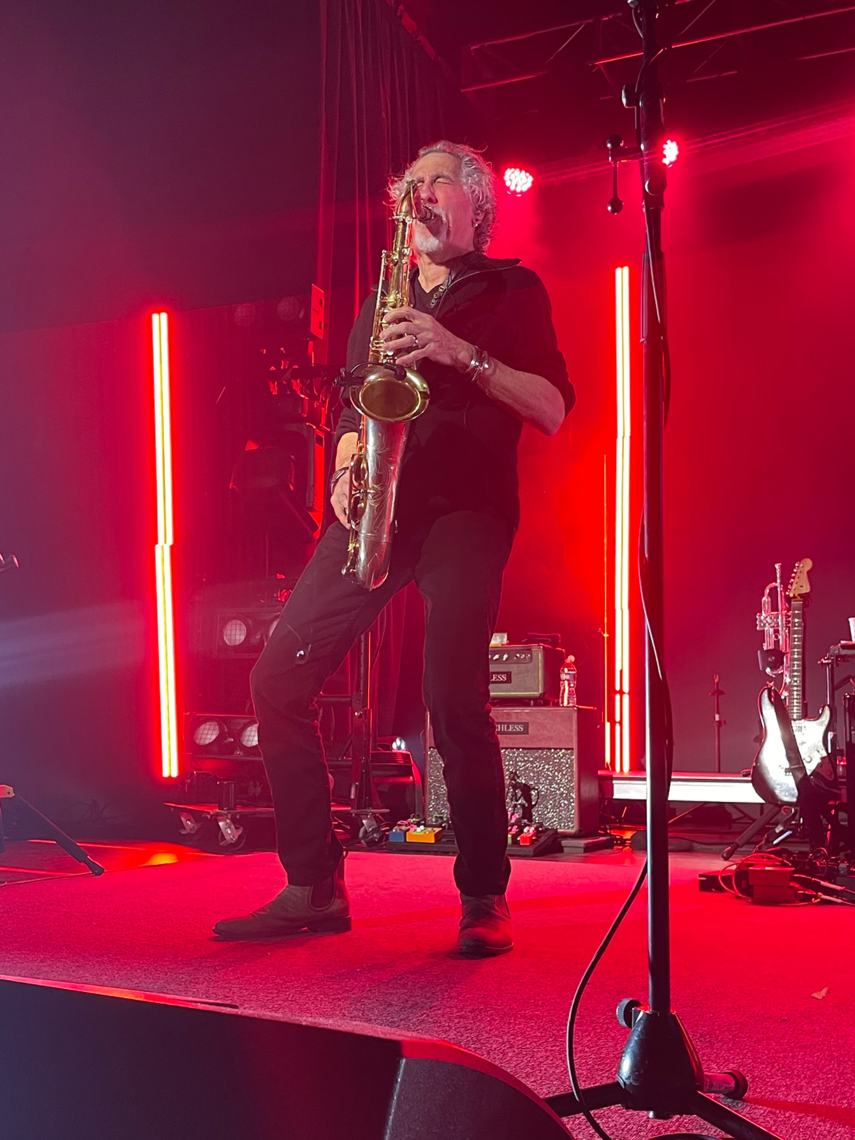 Stan Harrison on stage playing a saxophone.