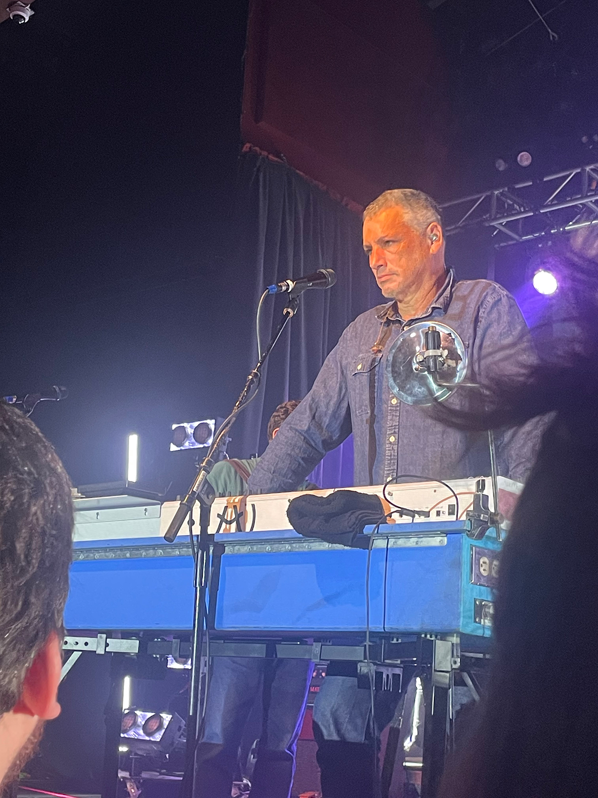 Dan Miller on stage standing behind the keyboard.