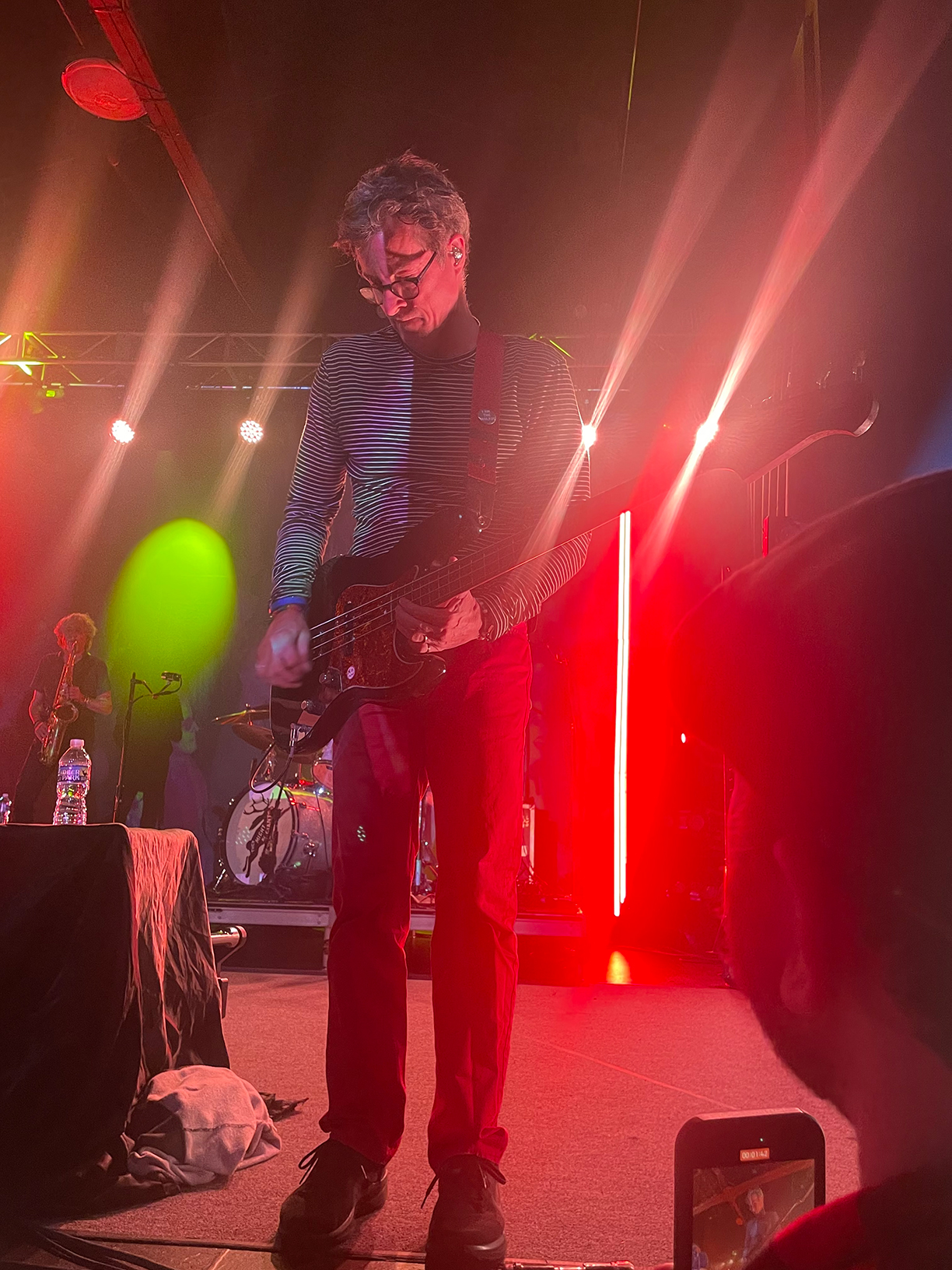 Danny Weinkauf on stage playing bass guitar.