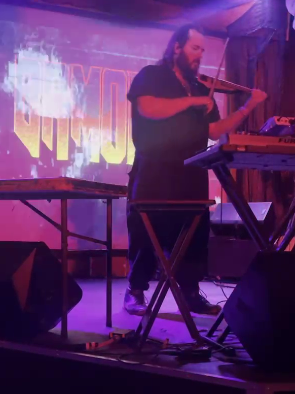 Dr Motherfucker on stage playing the eletric violin.