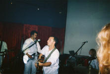 Burns performing on stage with his band.