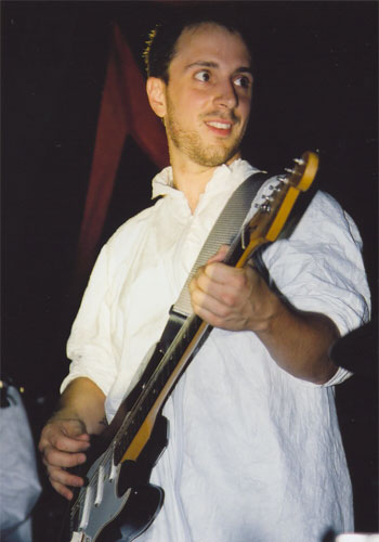 Burns playing guitar on stage.