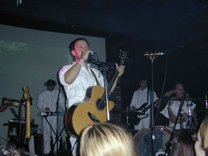 Burns and his band performing on stage.