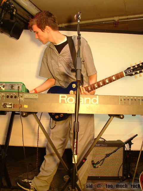 Derek playing keyboard on stage.