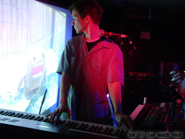 Derek playing keyboard on stage.