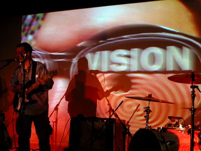 Burns doing sound check while an image is being projected behind him.