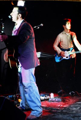 Burns at microphone on left, Derek on right.