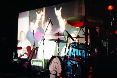 Image of a group of people projected on the screen.