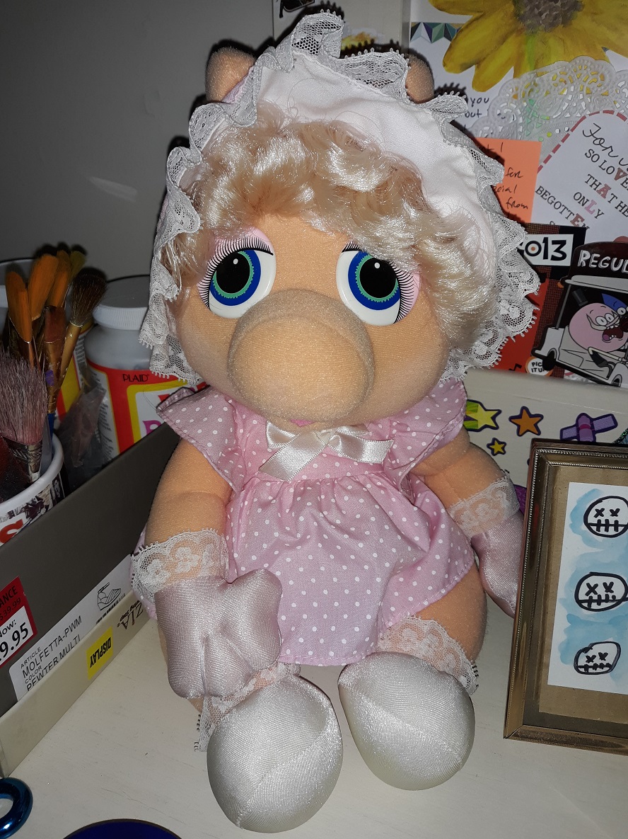 A plush doll of a baby version of Miss Piggy.