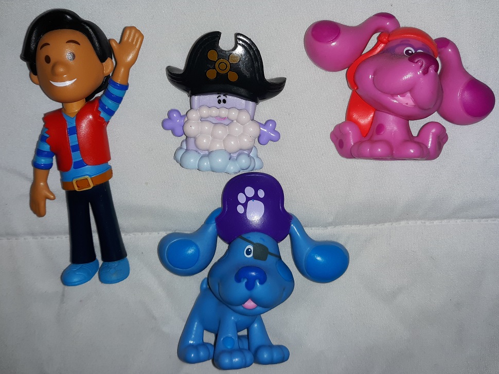A group of plastic Blue's Clues and You figurines all dressed up as pirates that consists of Josh, Slippery Soap, Magenta, and Blue.