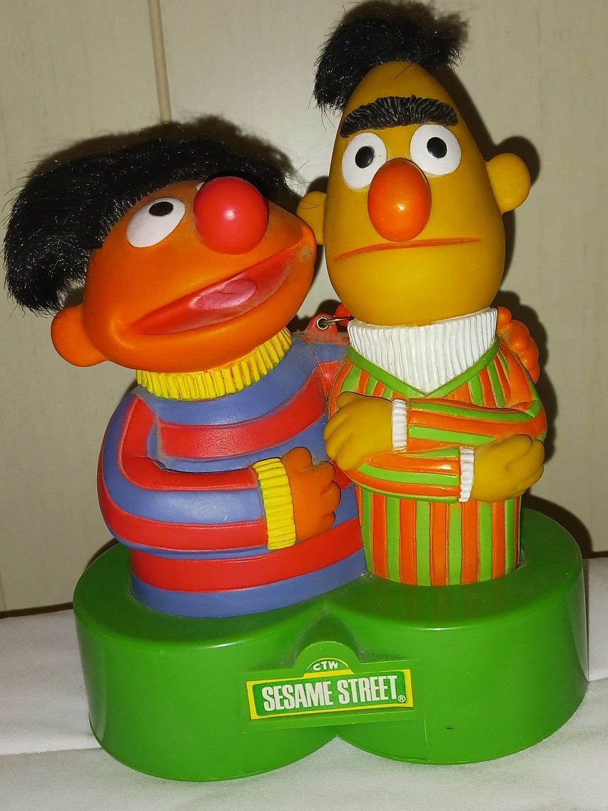A plastic radio of Bert and Ernie together.
