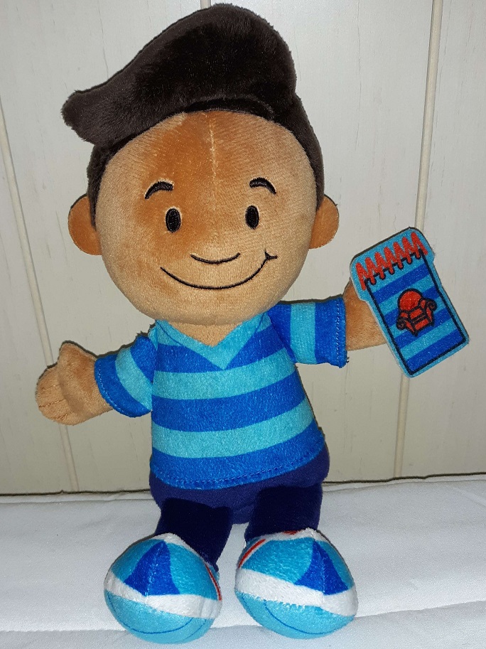 A plush doll of Josh with an embroidered face. He is holding his notebook phone in one of his hands.