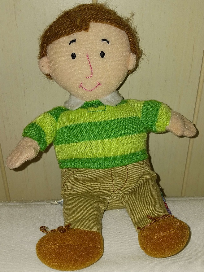 A small plush doll of Steve. He has yarn hair and an embroidered face.