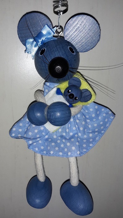 A wooden blue mouse wearing a blue bow on her ear and a blue dress with white polka dots on it. She is holding her little mouse baby.