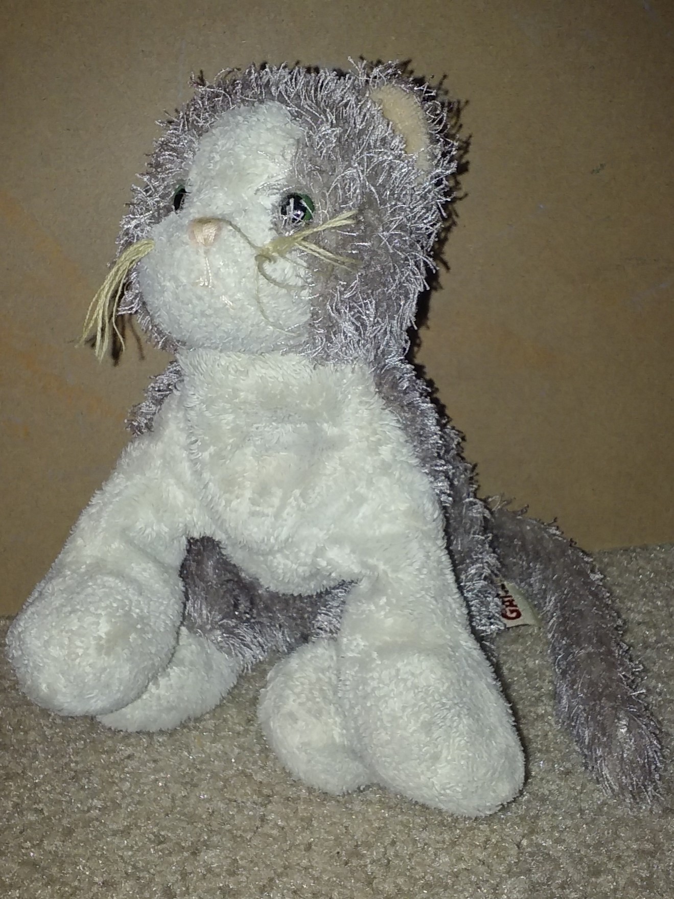 A doll of a grey and white cat.