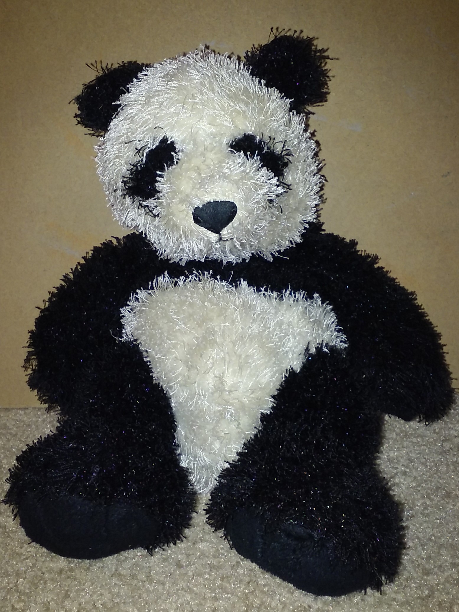 A doll of a black and white panda bear.